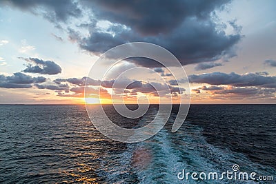 Nice Sunset Beyond Ships Wake Stock Photo