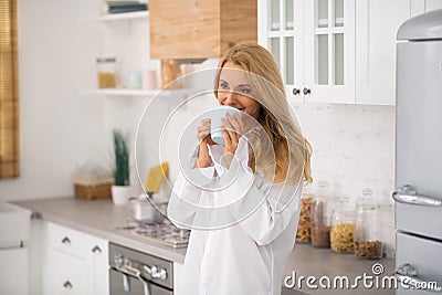 Pretty woman with cup near face Stock Photo