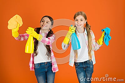 Nice and tidy. Girls with mist spray and rag ready for cleaning. Household duties. Little helper. Girls cute kids love Stock Photo