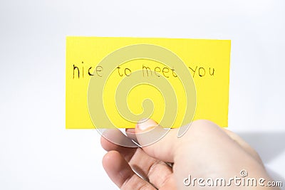 Nice to meet you handwrite with a hand on a yellow paper Stock Photo