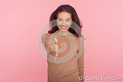 Nice to meet you! Portrait of hospitable young woman with brunette hair giving hand to handshake and smiling Stock Photo