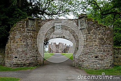 View through stone gate towards Scone Palace Stock Photo