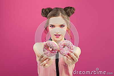 Nice woman with donuts on vivid yellow background, diet concept Stock Photo