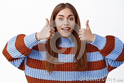 Nice work, well done. Smiling young woman praise good choice, showing thumbs up gesture, approve and like, say yes Stock Photo