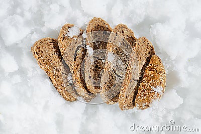 Nicely arranged frozen grey bread slices in a grinded ice. top view. Stock Photo