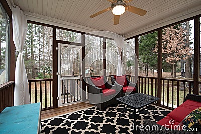 A nicely decorated screened in porch. Stock Photo