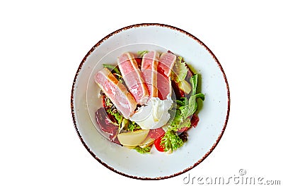 Nicoise salad of rare fried tuna, potato, salad mix and poached egg in white plate, isolated on white Stock Photo