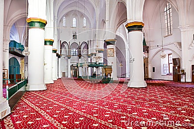 Nicosia, Cyprus - Oct 4 2018: Beautiful red and white interior of islamic Selimiye Mosque in Cypriot Nicosia. White walls, columns Editorial Stock Photo