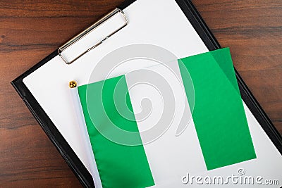 Nigeria document, mockup for text on clipboard, white sheet of paper in a folder for notes with Nigeria flag Stock Photo