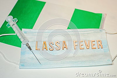 Nigerian flag under words Lassa fever outbreak concept. protective breathing mask and syringe. Lassa hemorrhagic fever LHF endemic Stock Photo