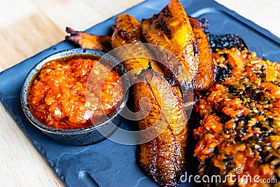 Nigerian Food: Delicious fried plantain with red chilli souce Stock Photo