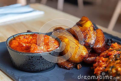Nigerian Food: Delicious fried plantain with red chilli souce Stock Photo