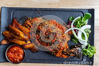 Nigerian Food: Delicious Roasted fish and fried plantain Stock Photo