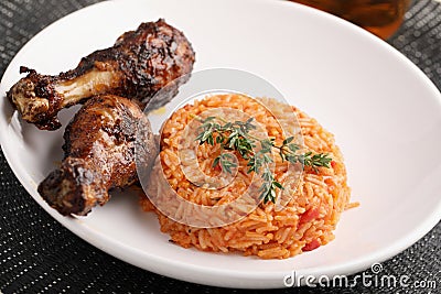 Nigerian Jollof Rice with chicken thigh Stock Photo