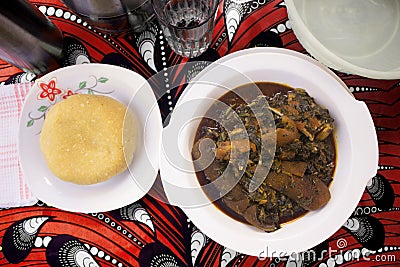 A Nigerian meal of Yellow Eba and Vegetable soup - Top View Stock Photo