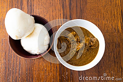 Nigerian Pounded yam wrapped in plastic served with Banga Soup Stock Photo