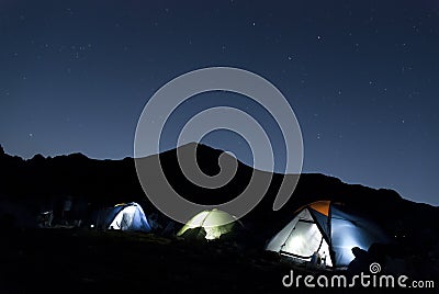 Nigh mountan landscape with tents under the stars Stock Photo