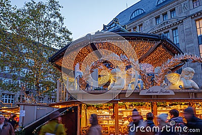 Night atmosphere with crowd of people and illuminated decorated stalls at Christmas Market. Editorial Stock Photo