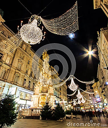 Night Atmospheric View, Motion Blurred of Graben, Busy Crowded Vienna`s Shopping Street with Memorial Plague Column Pestsaule Stock Photo