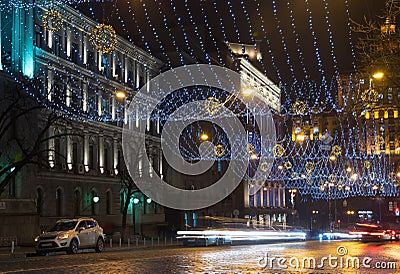 Night in the big city, the cars traveling on the highway and shines a blinding light. City, Kiev - december, 2017 Stock Photo