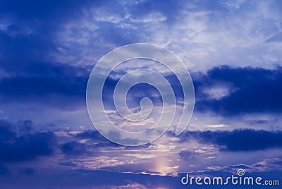 Night blue sky and moonlight background. The magic moon shines in the night sky through dark blue clouds Stock Photo