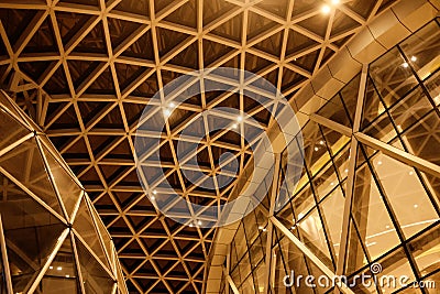 Night Building structures aluminum triangle geometry on facade of modern urban architecture..blur futuristic structures Stock Photo