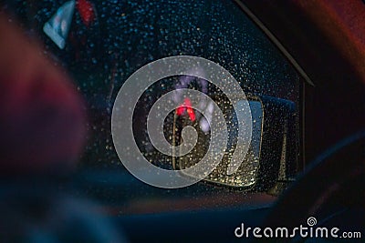 night car driving rain drops on window Stock Photo