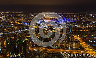 night city with lights skyscrapers and roads, view from drone Stock Photo