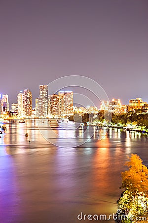 Night city photo with illuminating bright lights beside a river Stock Photo