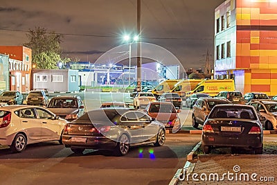 Night city scene, street photos, cars in the parking lot, foreign cars. Editorial Stock Photo