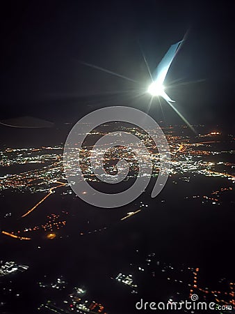 Night city under the wing of an airplane Stock Photo