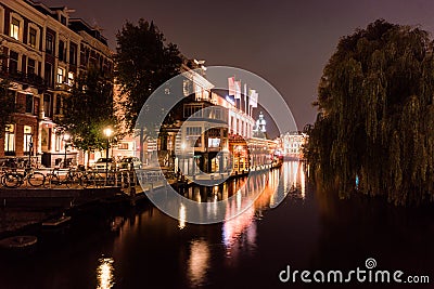 Night city view of Amsterdam bridge and typical dutch houses, Holland, Netherlands. Editorial Stock Photo