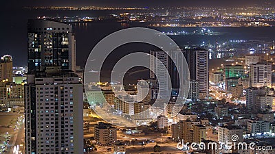 Cityscape of Ajman from rooftop at night timelapse. Ajman is the capital of the emirate of Ajman in the United Arab Stock Photo