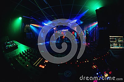 Night club with dancing people on dance floor, revelers at a party and music Board of the DJ Editorial Stock Photo