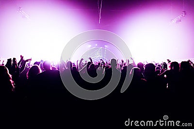 Night club silhouette crowd hands up at confetti steam stage Editorial Stock Photo