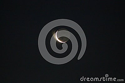 Night crescent moon illuminated by sunlight Stock Photo