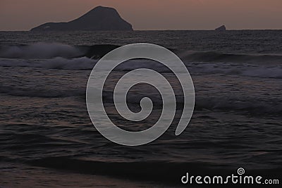 The sun is about to rise on the horizon, the sky and the sea take on warm colours Stock Photo