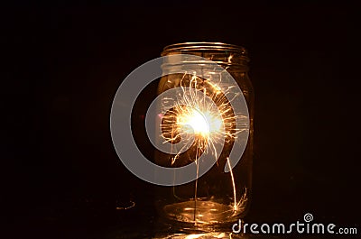 Night fireworks sparkler burning inside glass jar 1st version Stock Photo