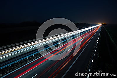 Night highway with car traffic and blurry lights Stock Photo