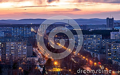 Night houses with a gleam of sunset in the city center Stock Photo