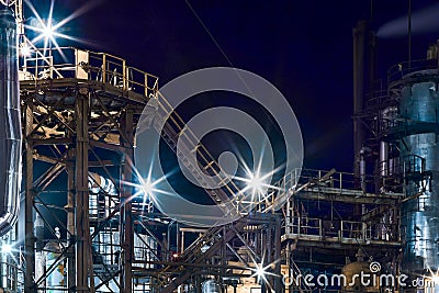 Night industrial petrochemical landscape. Reactors pipes stairs and columns. Large-capacity production enterprise Stock Photo