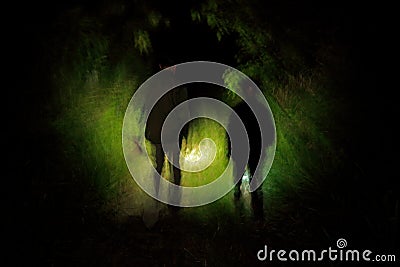 Night jungle walk in the tropic forest. Two man in the dark night, Corcovadon NP, Costa Rica. Light in the tropic green vegetation Stock Photo