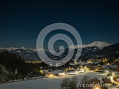 Night landscape with starry sky in the Alps, with street lights and villages in the valley, Millstatter See Stock Photo