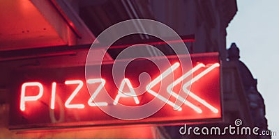 Night light red neon pizza sign in the street Stock Photo