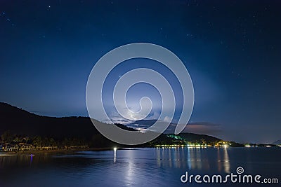 Night lightning strike over mountains resort with star at the Khanom beach of Thailand. Stock Photo