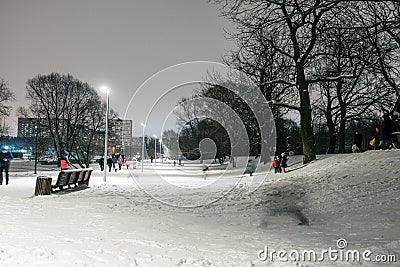 Night lphotography, kids play in the park in Moscow in winter with snow Editorial Stock Photo
