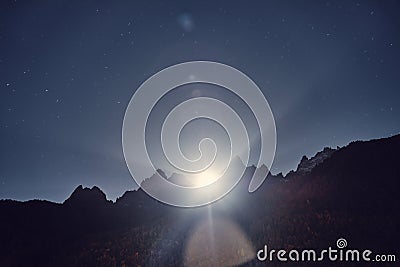 Night mountain landscape. Moonlight from behind Alps mountains at night Stock Photo