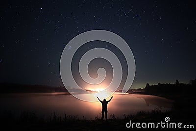 Night near lake with man's silhouette Stock Photo