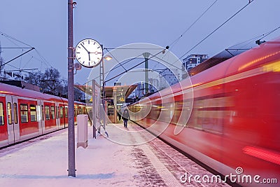 Night outdoor view on platform railway station in winter in Germany. Editorial Stock Photo