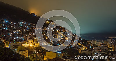 Night over Brazilian favelas on the hill with city downtown below, Rio De Janeiro, Brazil Stock Photo